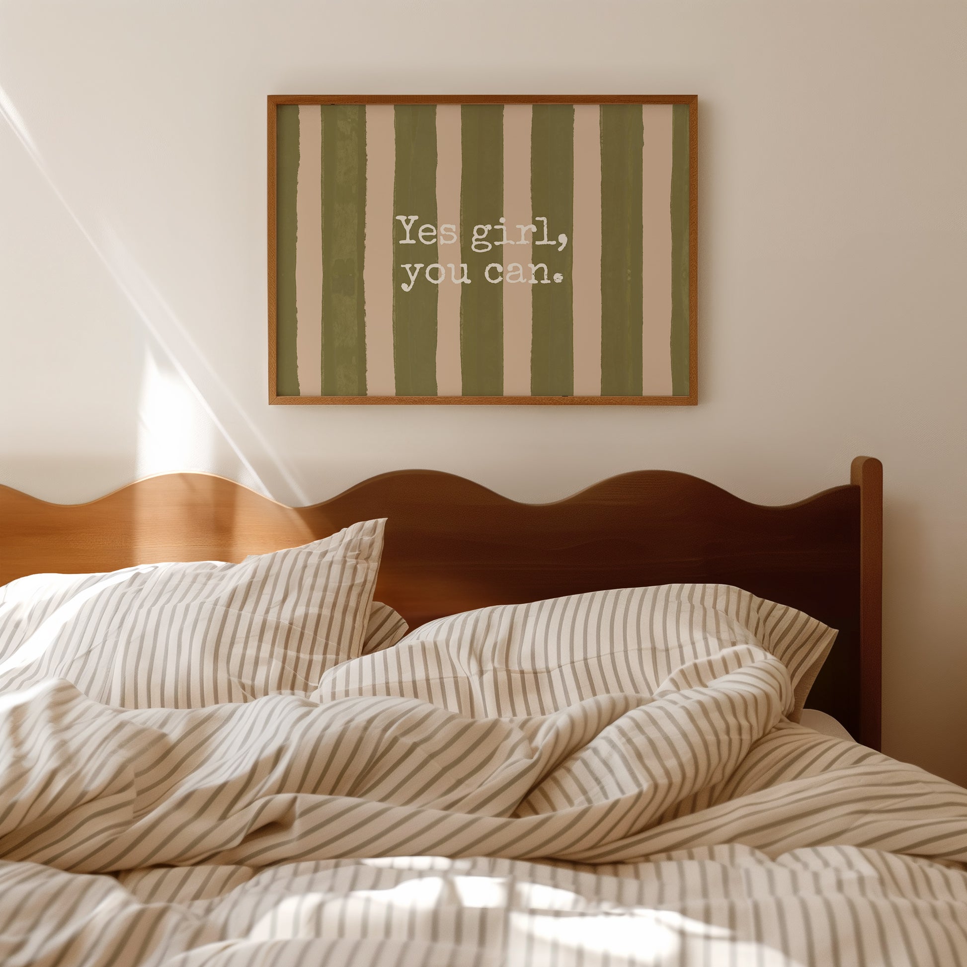 Horizontal wall print with bold olive green brush stroke vertical stripes on a warm cream background with white typewriter font text reading Yes girl, you can.