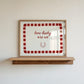 White print with a red and pink striped border featuring the handwritten quote 'how lucky are we' and a horseshoe illustration