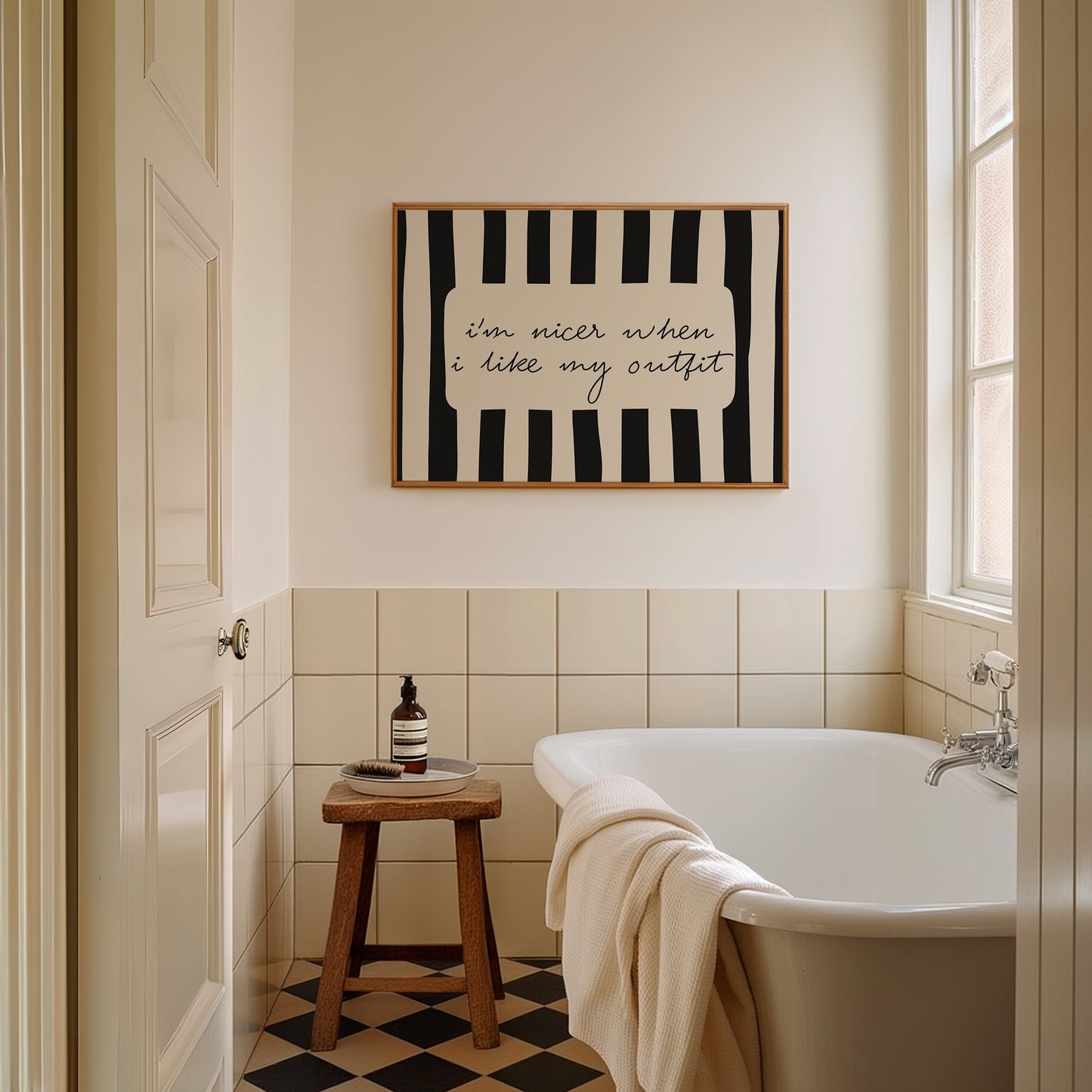 Horizontal print with bold black and white vertical stripes framing the handwritten cursive quote "i'm nicer when I like my outfit" in a rounded cream panel.