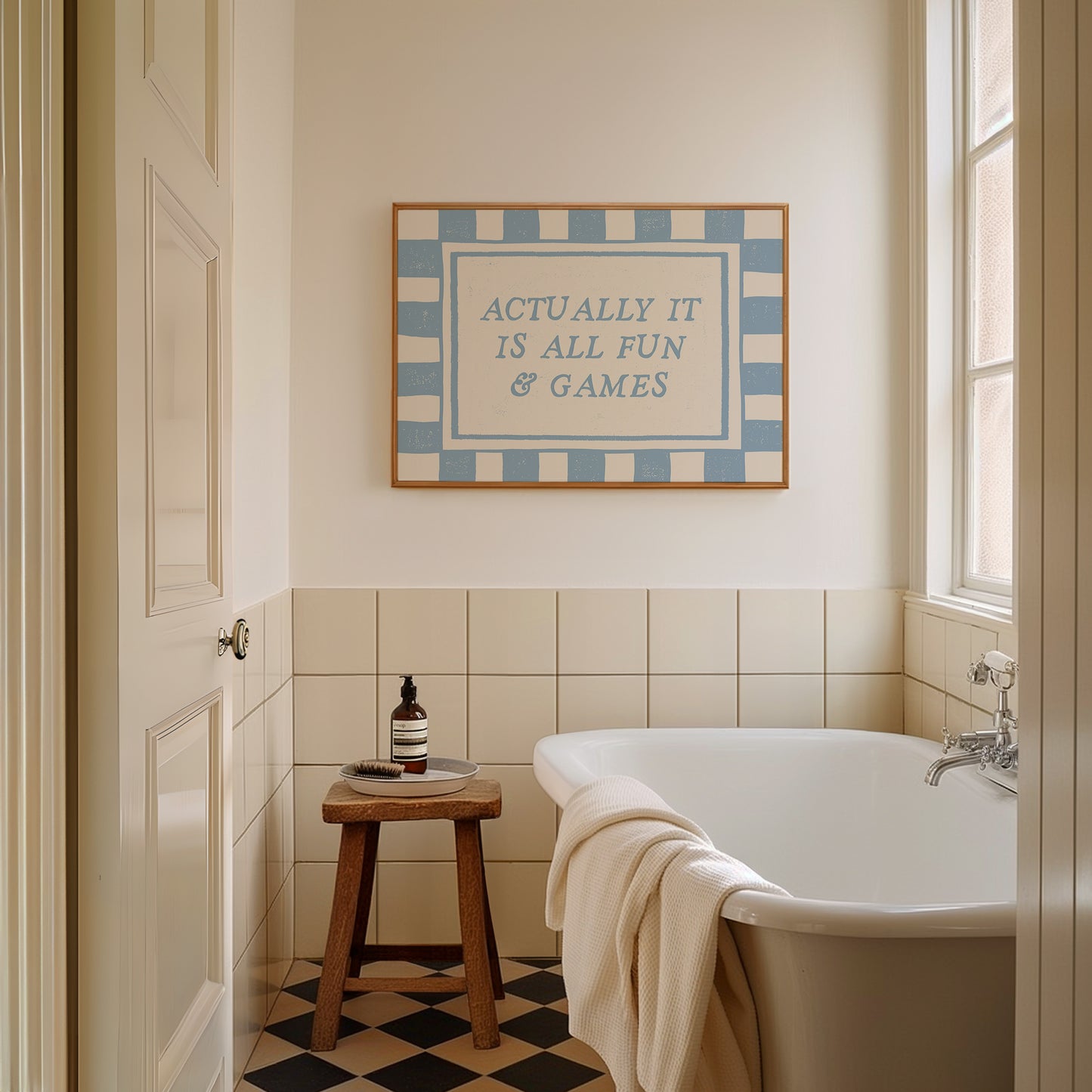Actually It Is All Fun & Games blue checkered horizontal art print above freestanding bath — sassy bathroom wall decor