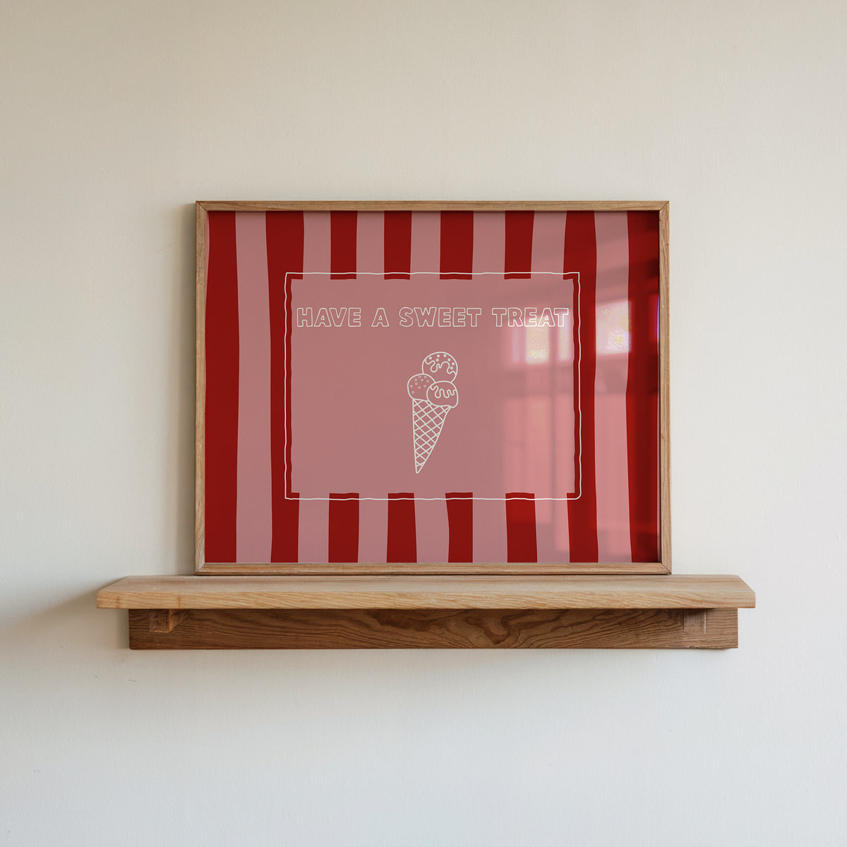 Horizontal print with bold red and pink vertical stripes and a hand-drawn ice cream cone illustration inside a rectangular border, with the words "HAVE A SWEET TREAT" in outlined block lettering.