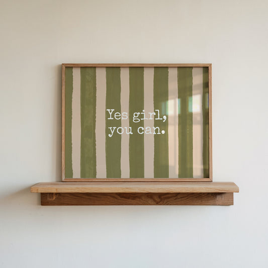 Horizontal wall print with bold olive green brush stroke vertical stripes on a warm cream background with white typewriter font text reading Yes girl, you can.