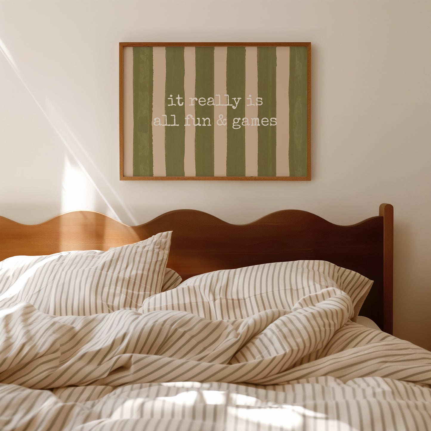 Horizontal print with olive green and cream hand-painted vertical stripes and the quote "it really is all fun & games" in white typewriter-style lettering across the center.