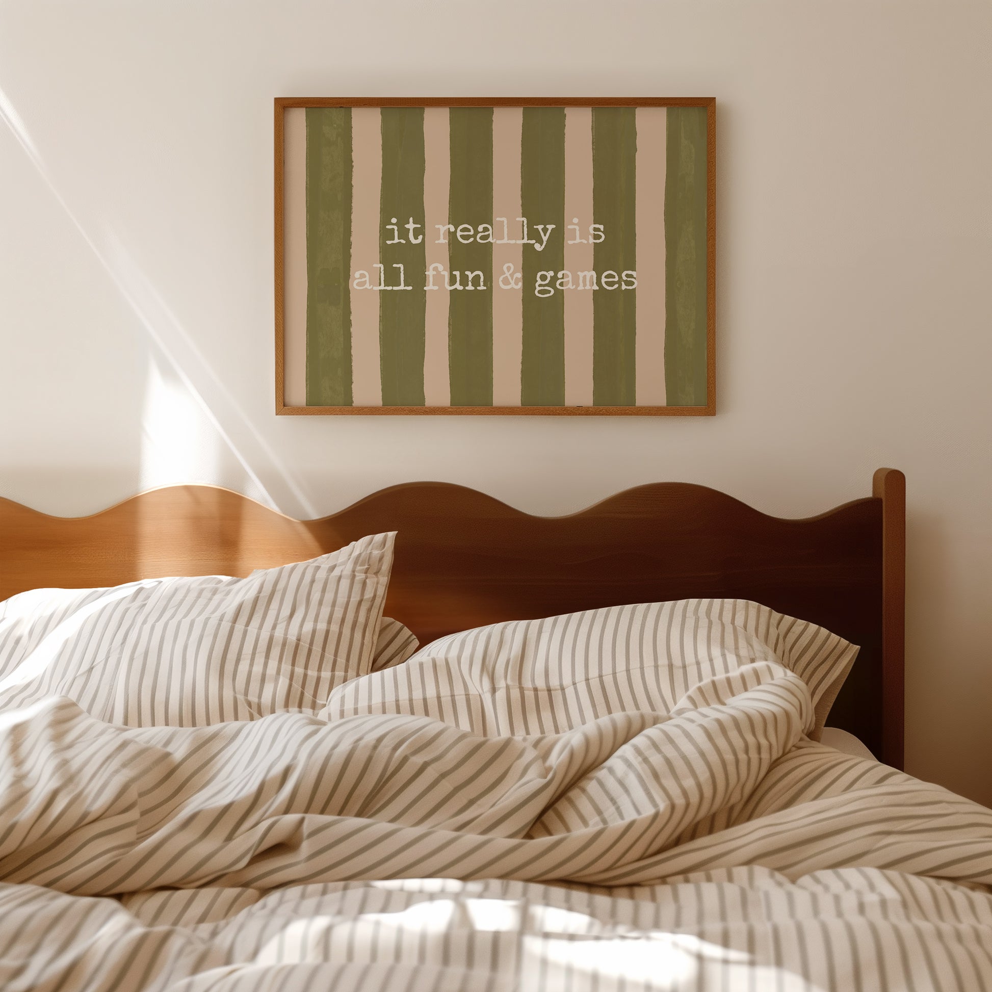 Horizontal print with olive green and cream hand-painted vertical stripes and the quote "it really is all fun & games" in white typewriter-style lettering across the center.