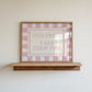 Horizontal wall print with pink and cream checkered border and a cream centre text box in bold serif typography reading Cute Shoes! Take Them Off. in dusty pink