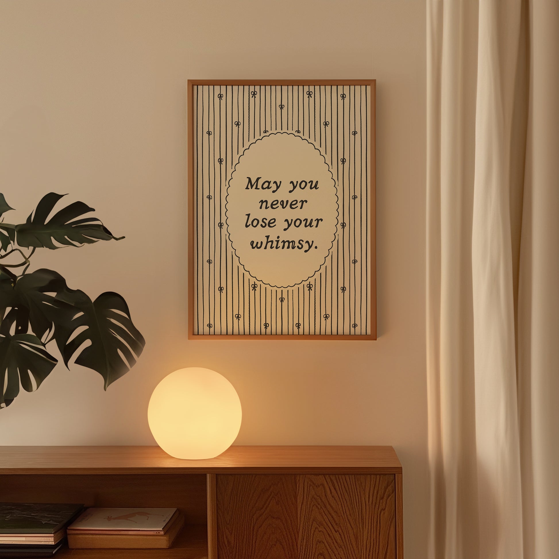 Vertical print with the quote "May you never lose your whimsy." in italic serif type inside a scalloped oval frame, surrounded by thin navy pinstripes decorated with small hand-drawn bows on a cream background.
