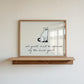 Horizontal minimalist Halloween print of a black cat wearing a white ghost sheet costume with cut-out eyes, above the handwritten cursive quote "all guests must be approved by the house ghost." on a cream background.
