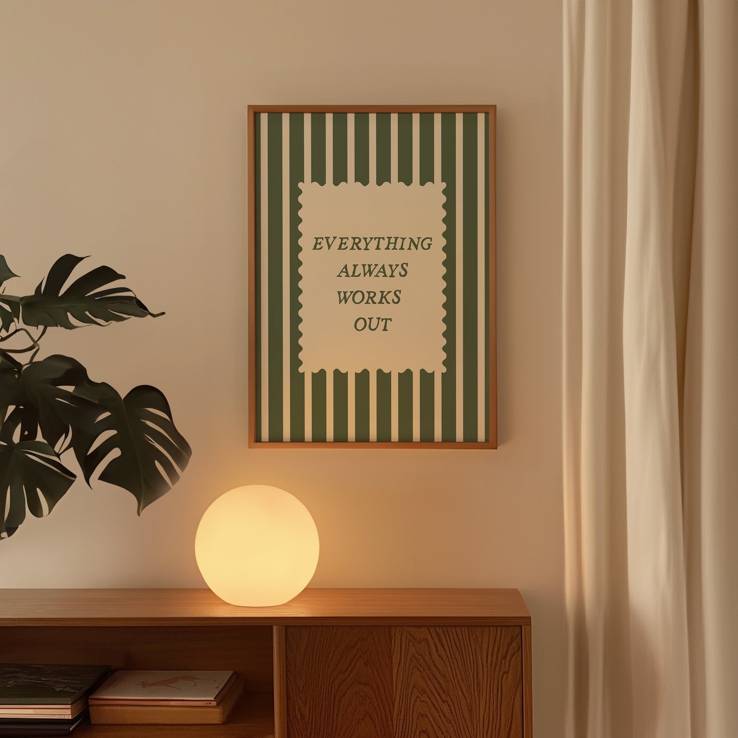 Vertical wall print with bold forest green vertical stripes and a cream scalloped text box reading Everything Always Works Out in dark green serif typography