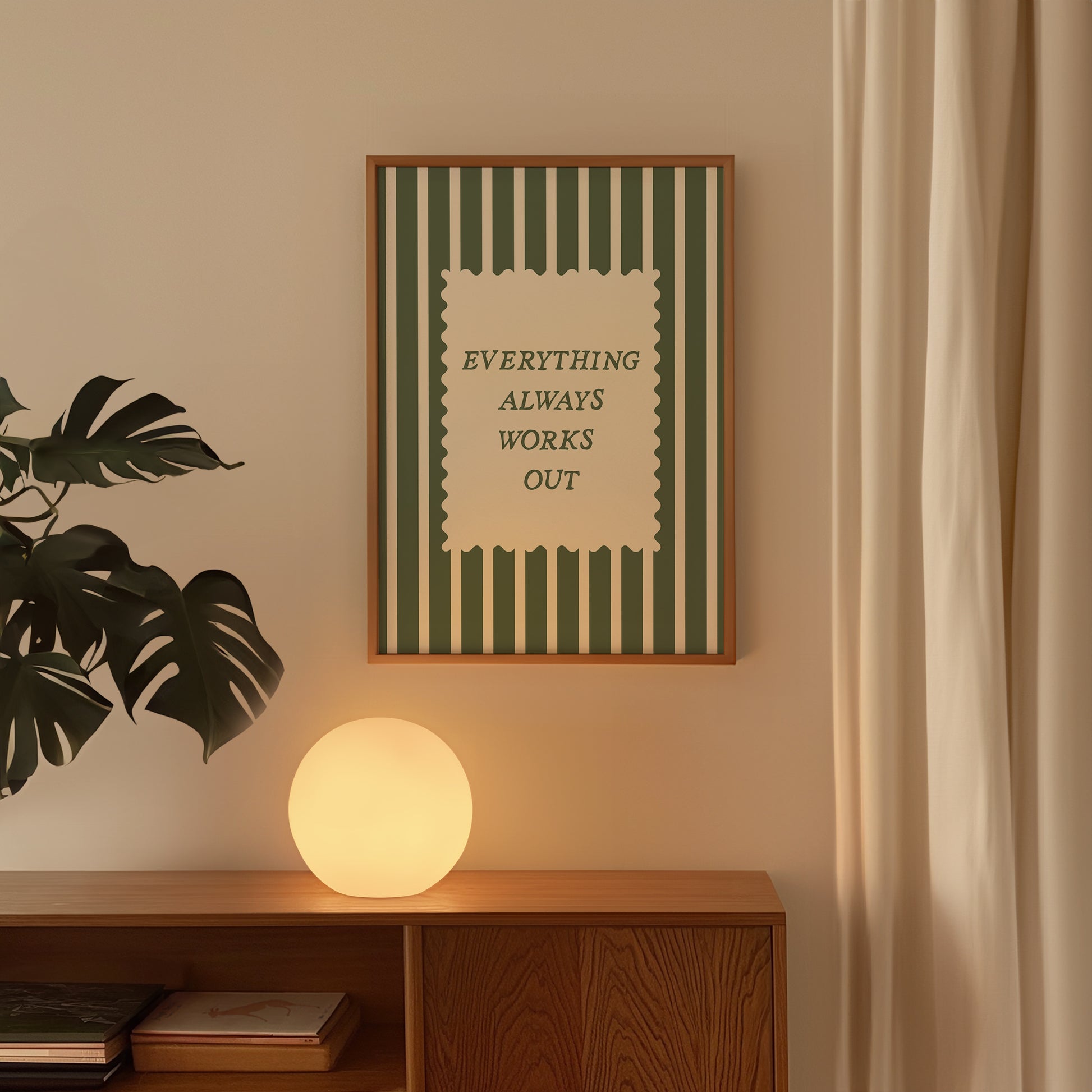 Vertical wall print with bold forest green vertical stripes and a cream scalloped text box reading Everything Always Works Out in dark green serif typography
