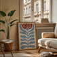 Set of five prints in rust and dusty blue: "How lucky are we" with a horseshoe, "So happy you are here," "What's for dinner?" in a checkered border, "This feels like home" on stripes, and a floral illustration