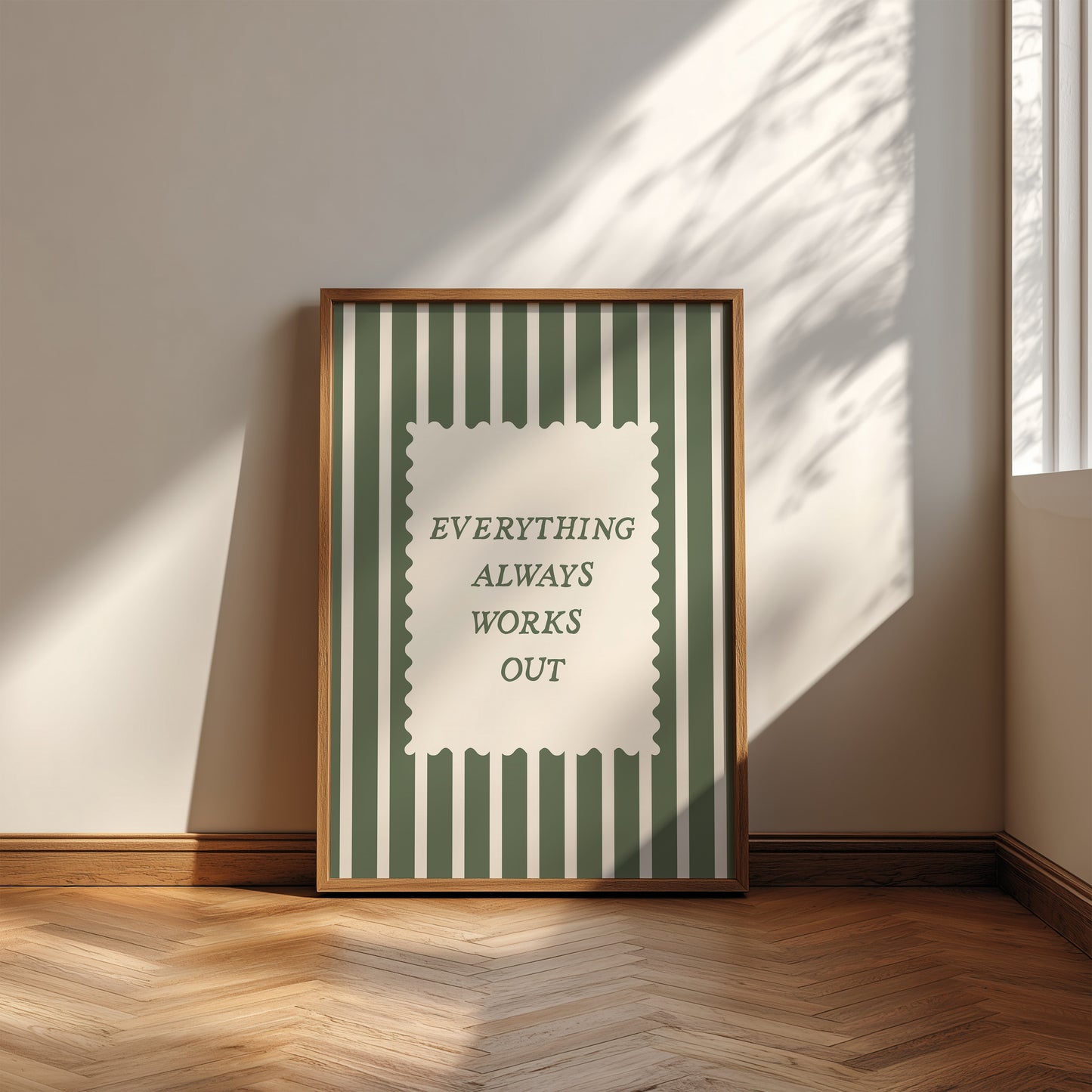 Vertical wall print with bold forest green vertical stripes and a cream scalloped text box reading Everything Always Works Out in dark green serif typography