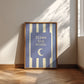 Portrait digital print with blue-and-cream striped background featuring a rounded blue panel with the text "Blame the moon." in cream lettering above a vintage-style crescent moon face illustration.