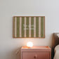 Horizontal wall print with bold olive green brush stroke vertical stripes on a warm cream background with white typewriter font text reading Yes girl, you can.