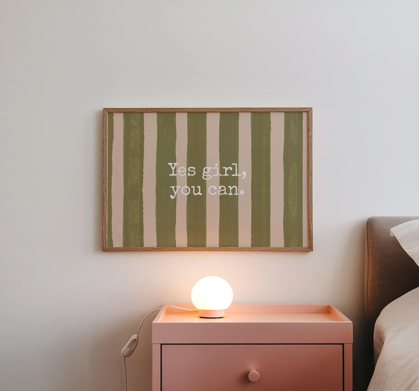 Horizontal wall print with bold olive green brush stroke vertical stripes on a warm cream background with white typewriter font text reading Yes girl, you can.