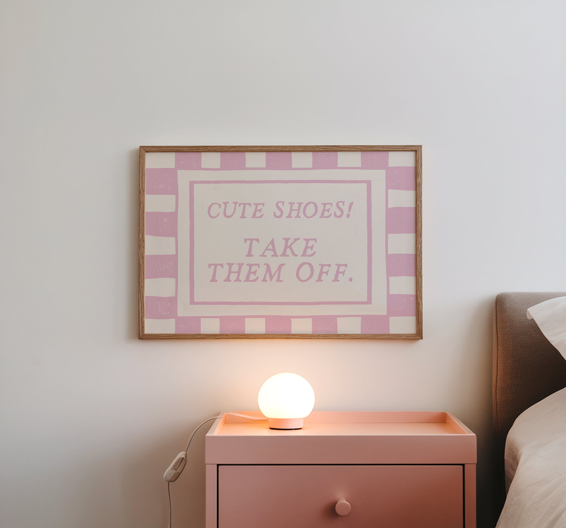 Horizontal wall print with pink and cream checkered border and a cream centre text box in bold serif typography reading Cute Shoes! Take Them Off. in dusty pink