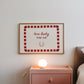 White print with a red and pink striped border featuring the handwritten quote 'how lucky are we' and a horseshoe illustration
