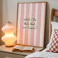 Print with soft pink hand-painted brush stroke stripes and the quote "What's the best that can happen" in script lettering.