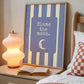 Portrait digital print with blue-and-cream striped background featuring a rounded blue panel with the text "Blame the moon." in cream lettering above a vintage-style crescent moon face illustration.