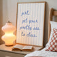 Vertical print with the handwritten cursive quote "girl, get your pretty ass to class." in blue script on a cream background with soft hand-painted pale blue vertical stripes.