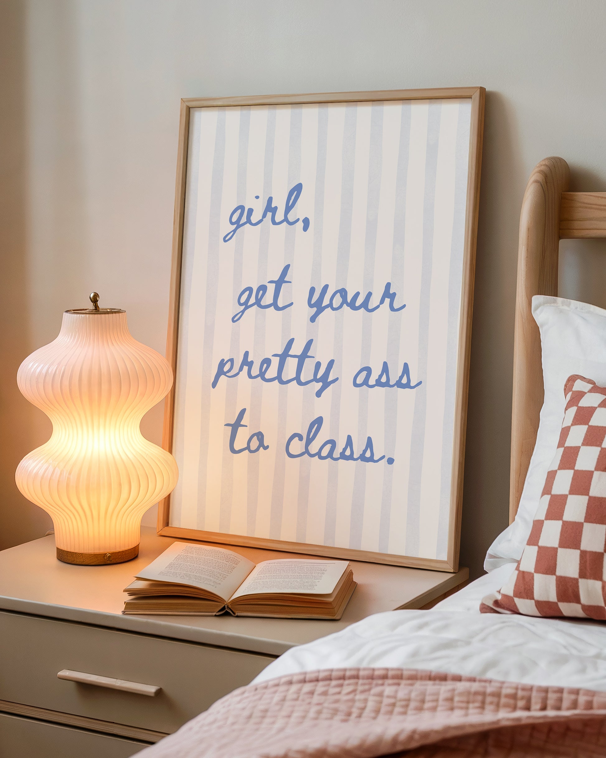 Vertical print with the handwritten cursive quote "girl, get your pretty ass to class." in blue script on a cream background with soft hand-painted pale blue vertical stripes.