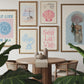 Set of 10 coastal watercolor prints in pink and blue: "Wild Like the Sea" beside a spiral shell illustration, "Stay Wild Ocean Child" in bold blue lettering, "Sea La Vie" in pink stamped typography, a mermaid lounging in a martini glass, pink starfish and seashell illustrations, a woman in a shell headdress, a beach umbrella watercolor, and "Meet me by the sea" in postcard-style script.