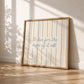 Cream print with thin vertical blue stripes and a hand-lettered quote in blue cursive script