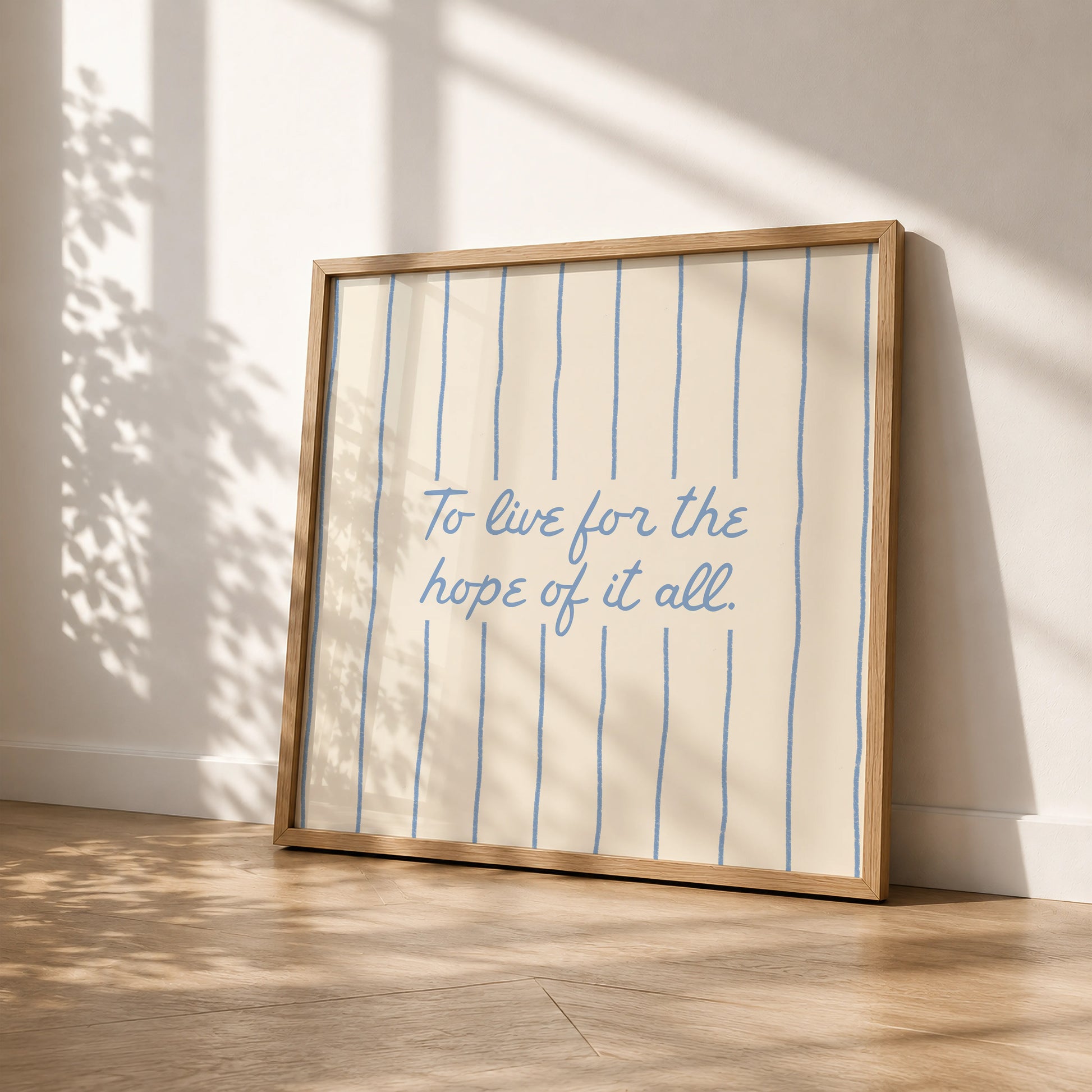 Cream print with thin vertical blue stripes and a hand-lettered quote in blue cursive script