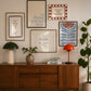 Set of five prints in rust and dusty blue: "How lucky are we" with a horseshoe, "So happy you are here," "What's for dinner?" in a checkered border, "This feels like home" on stripes, and a floral illustration