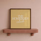 Square digital print with a mustard yellow background featuring "THE HOMEBODY" in bold cream serif type stacked above "club" in cream cursive script, centered typography layout.