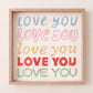 Square print with the words "Love You" repeated five times in different colors, fonts, and styles — blue, pink, gold, red, and green — stacked on a cream background.