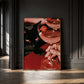 Vertical photographic print of a black cat with amber eyes resting beside two pink martini cocktails garnished with tiny orange pumpkins, on a deep red surface with a woman's hand holding one glass stem.