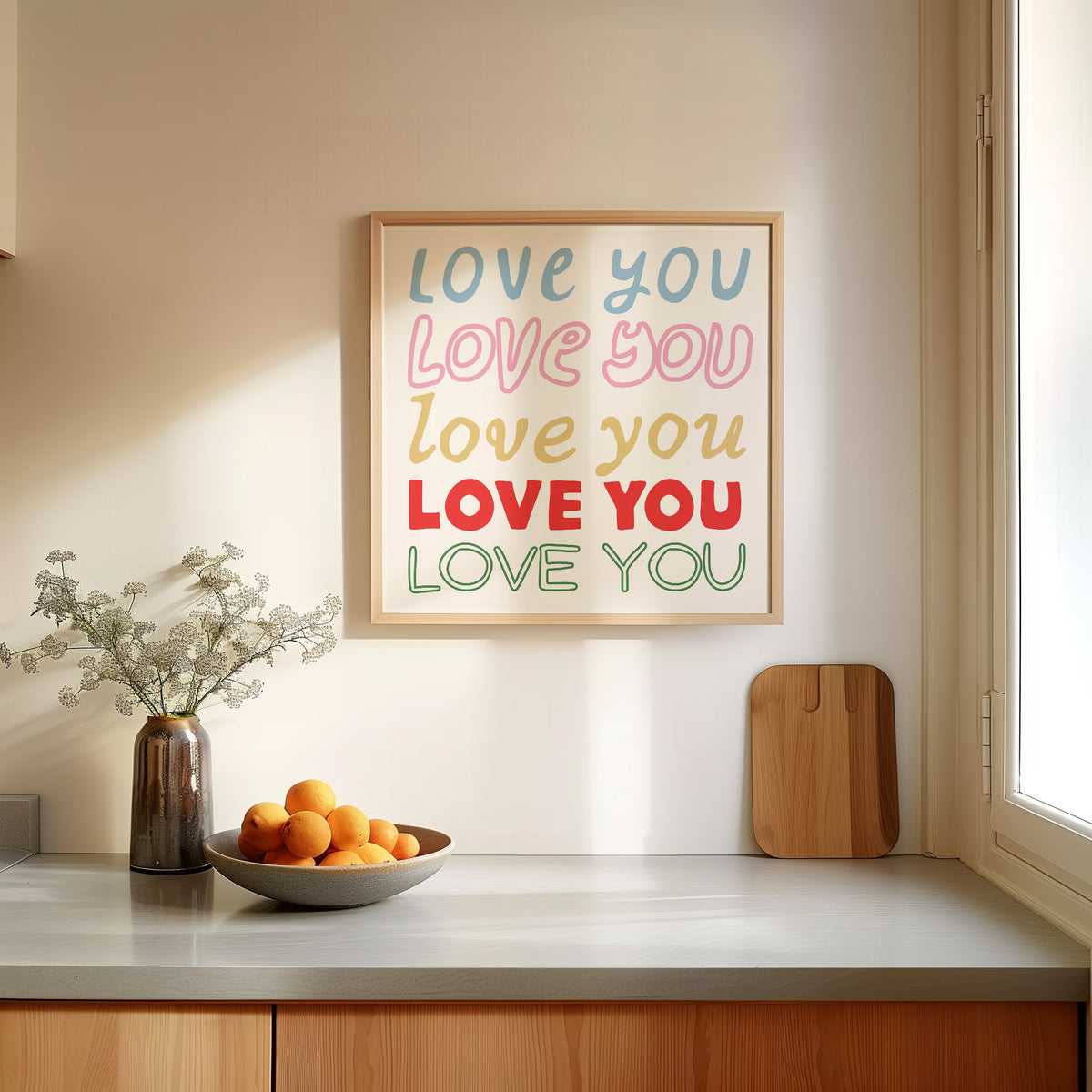 Square print with the words "Love You" repeated five times in different colors, fonts, and styles — blue, pink, gold, red, and green — stacked on a cream background.