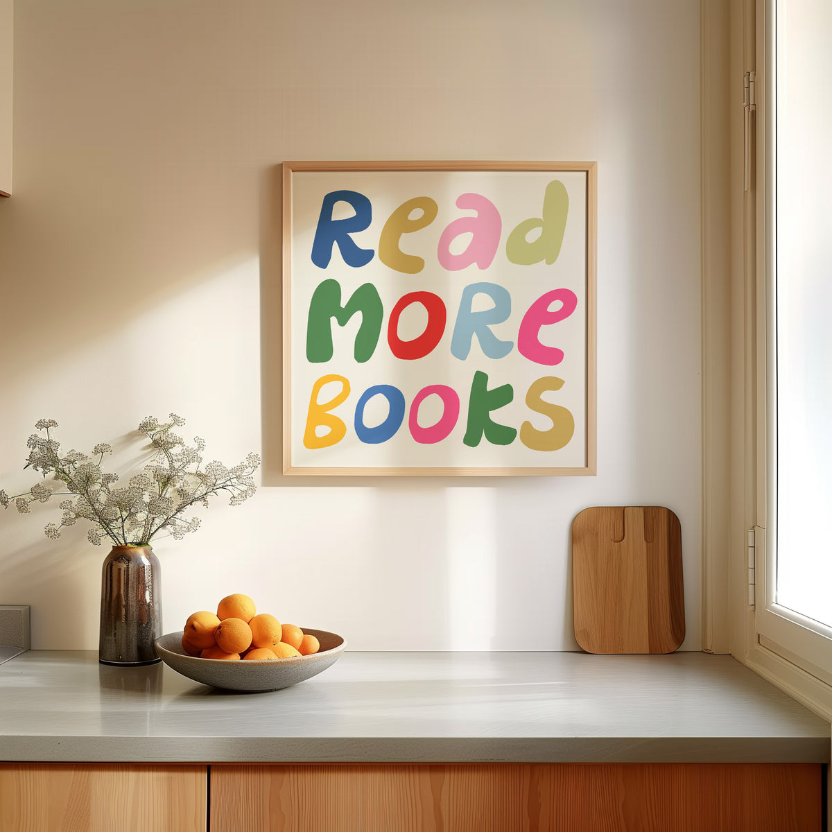 Square print with the words "Read More Books" in large multicolored bubble letters — blue, yellow, pink, green, red, and orange — stacked on three lines against a cream background.