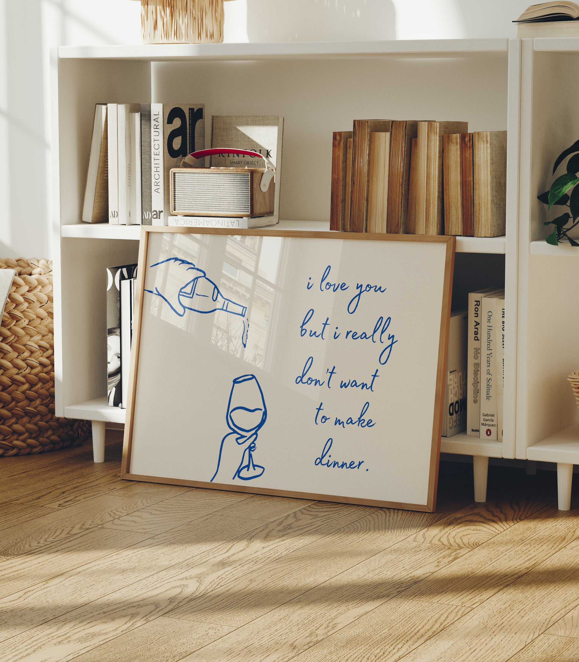 Print with hand-drawn blue line art of a bottle pouring wine into a glass beside the cursive quote "i love you but i really don't want to make dinner."