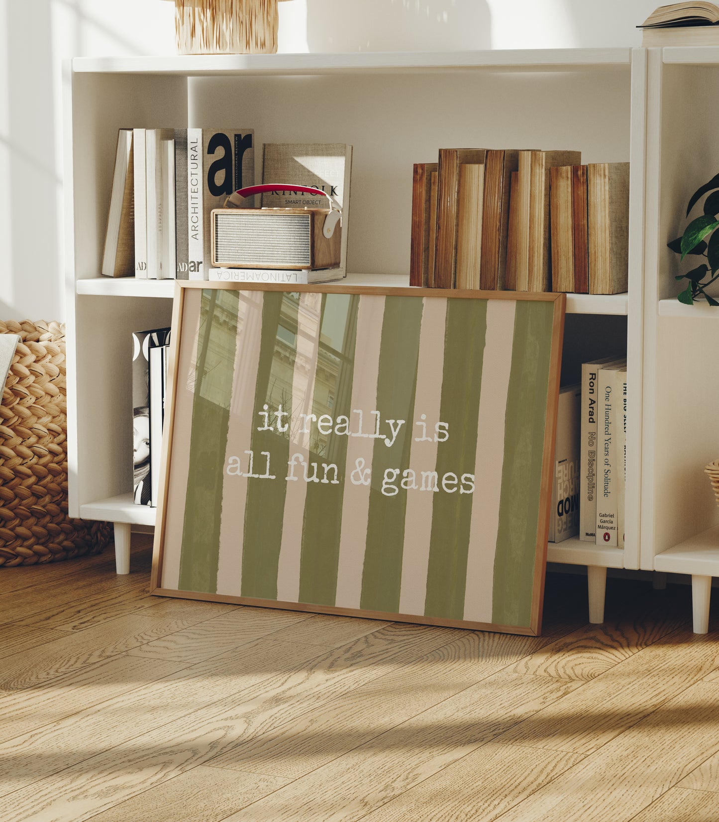 Horizontal print with olive green and cream hand-painted vertical stripes and the quote "it really is all fun & games" in white typewriter-style lettering across the center.