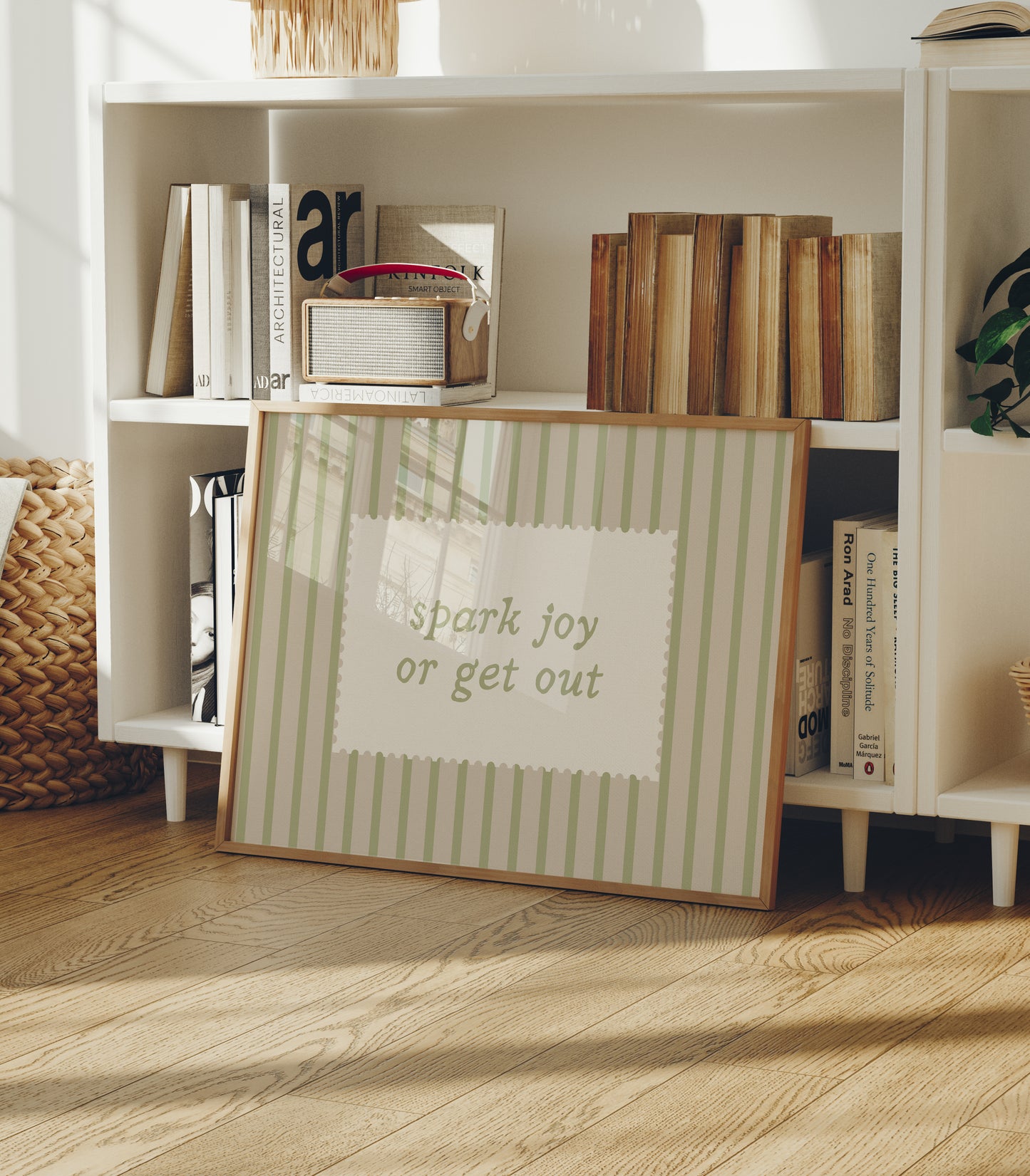 Horizontal wall print with soft sage green vertical stripes and a cream scalloped border text box reading spark joy or get out in matching sage green cursive font
