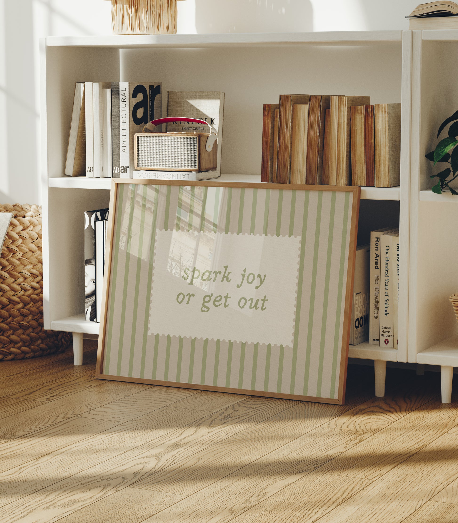 Horizontal wall print with soft sage green vertical stripes and a cream scalloped border text box reading spark joy or get out in matching sage green cursive font