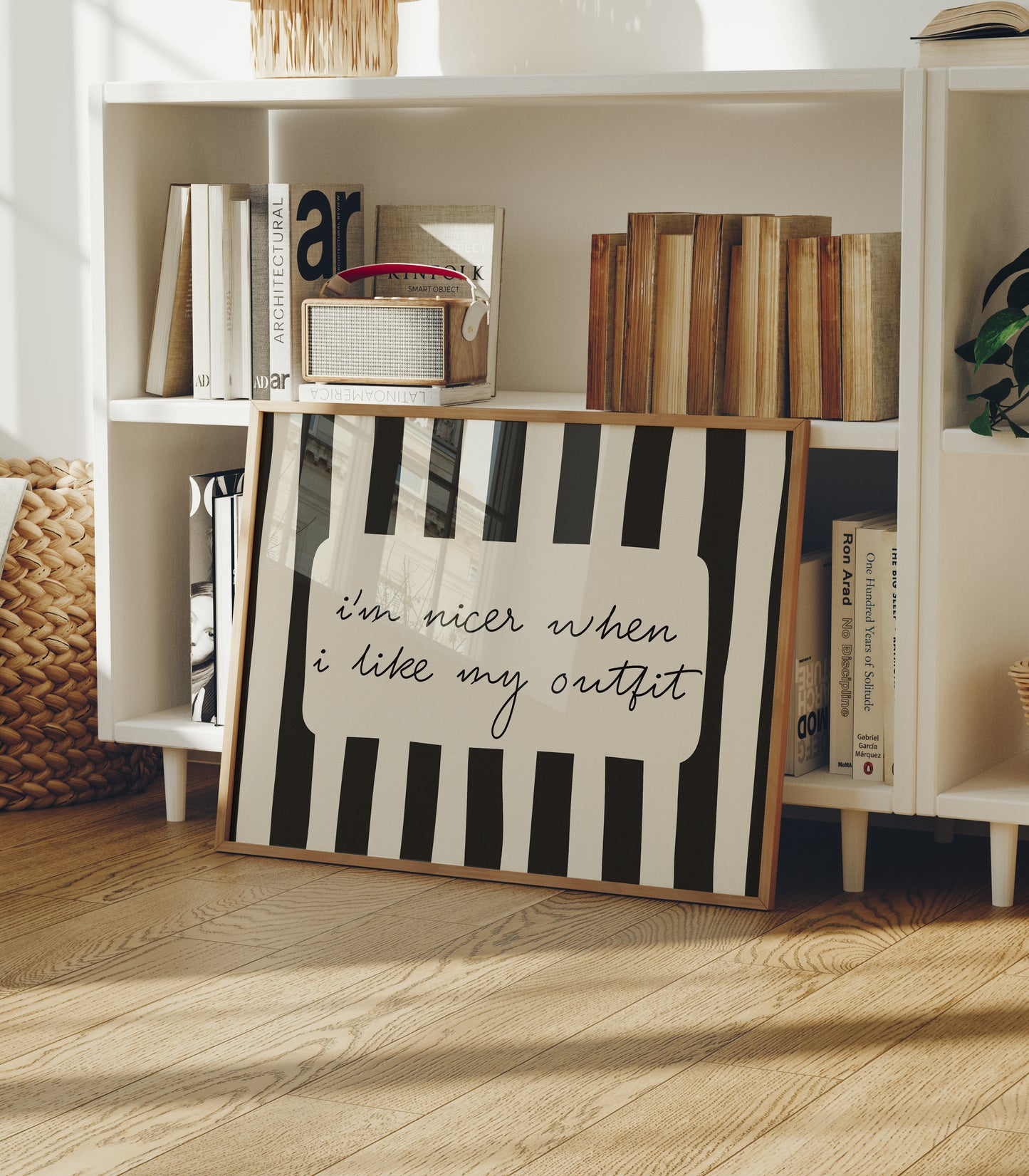 Horizontal print with bold black and white vertical stripes framing the handwritten cursive quote "i'm nicer when I like my outfit" in a rounded cream panel.