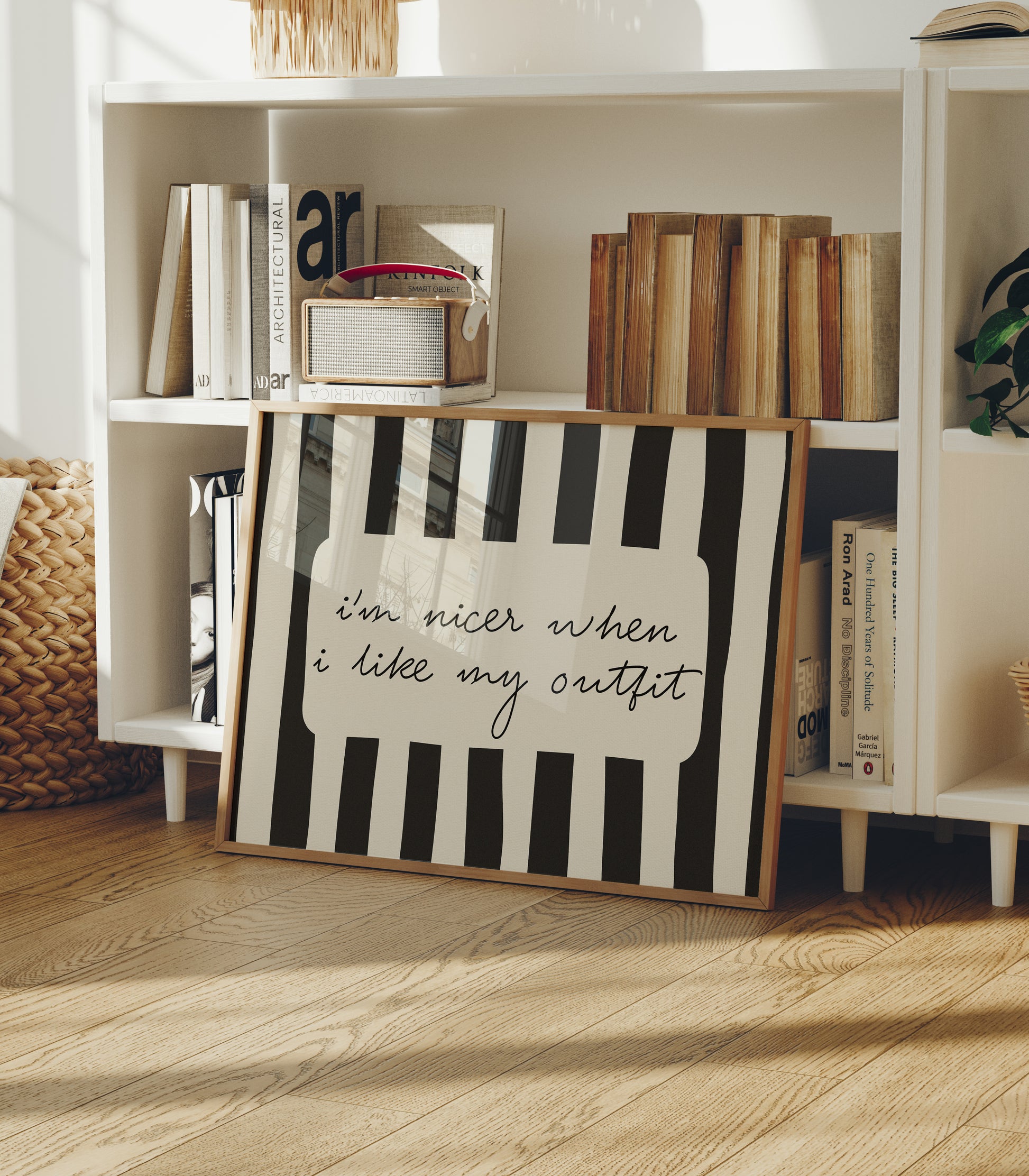 Horizontal print with bold black and white vertical stripes framing the handwritten cursive quote "i'm nicer when I like my outfit" in a rounded cream panel.