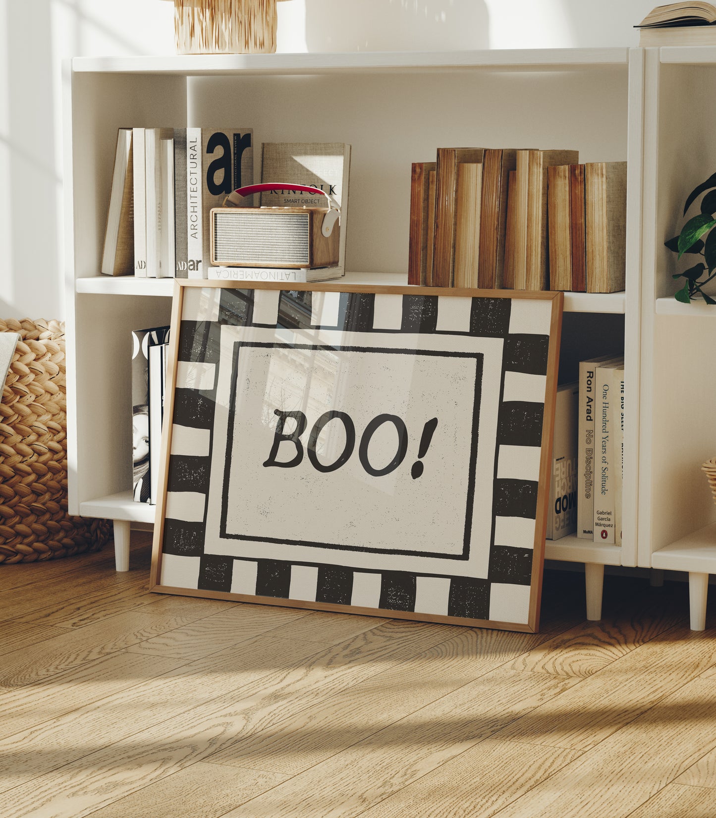 Horizontal print with a bold black and white checkered border framing the word "BOO!" in black hand-drawn type on a textured cream background.