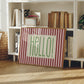 Horizontal wall print with bold dark red vertical stripes and a green dotted border text box reading HELLO! in chunky rounded green font