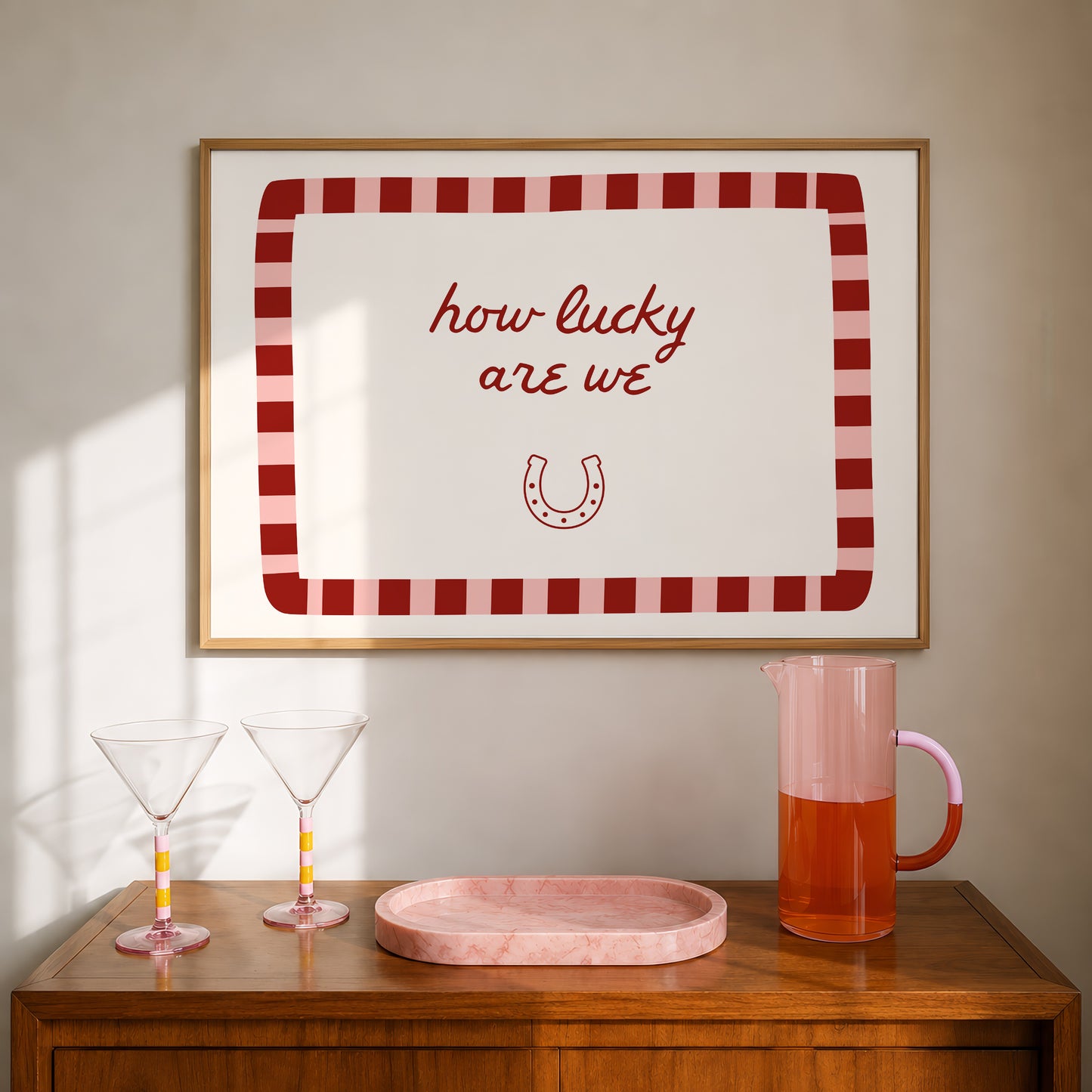 White print with a red and pink striped border featuring the handwritten quote 'how lucky are we' and a horseshoe illustration