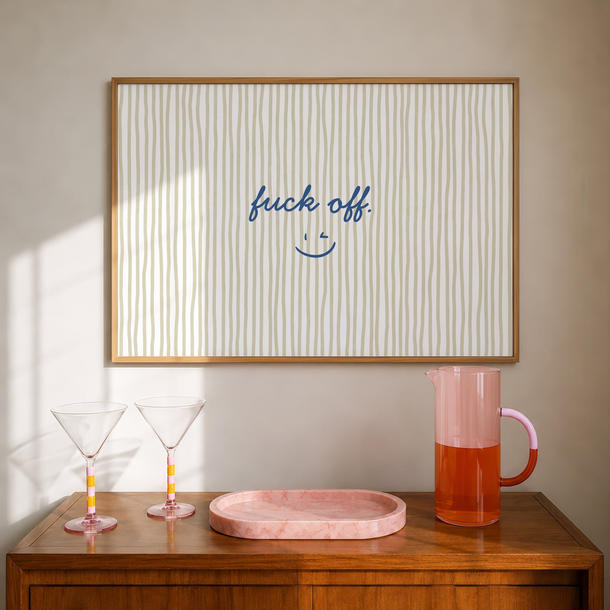 Beige and olive vertical striped print with "fuck off." in navy script and a small winking smiley face