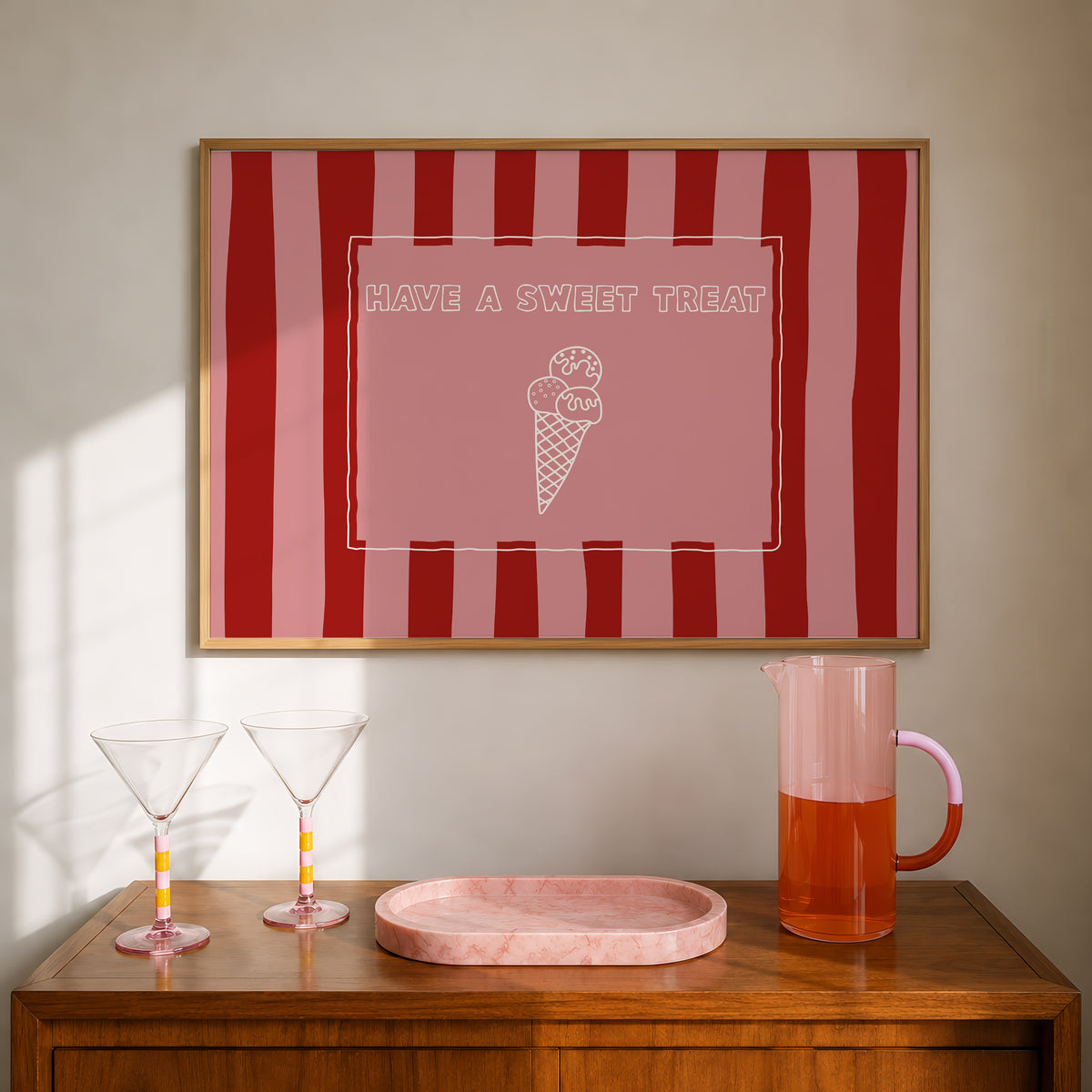 Horizontal print with bold red and pink vertical stripes and a hand-drawn ice cream cone illustration inside a rectangular border, with the words "HAVE A SWEET TREAT" in outlined block lettering.