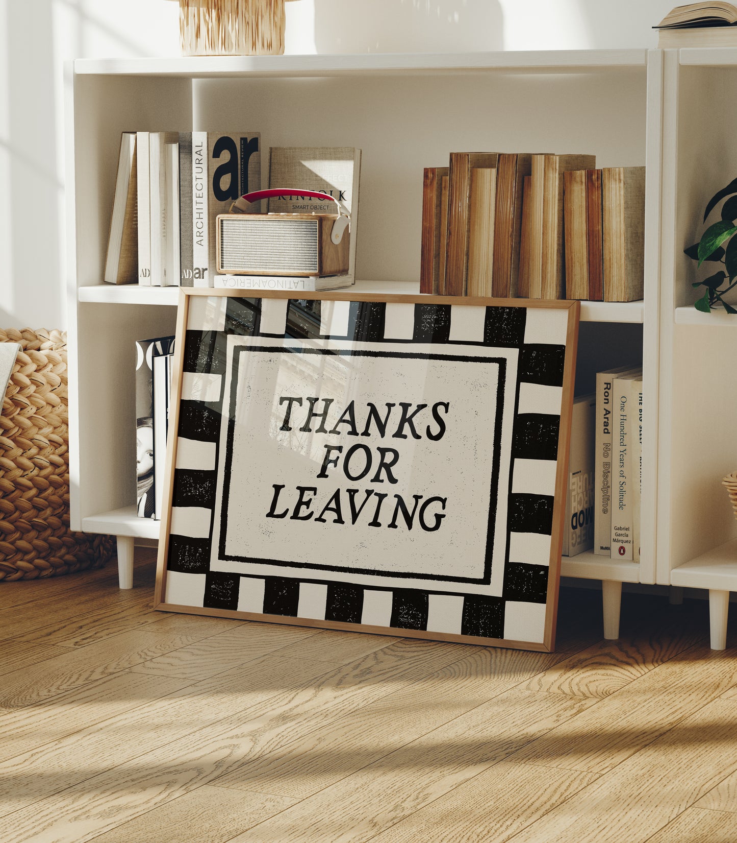 Horizontal wall print with bold black and cream vertical stripes forming a border around a cream text box with distressed black serif typography reading THANKS FOR LEAVING