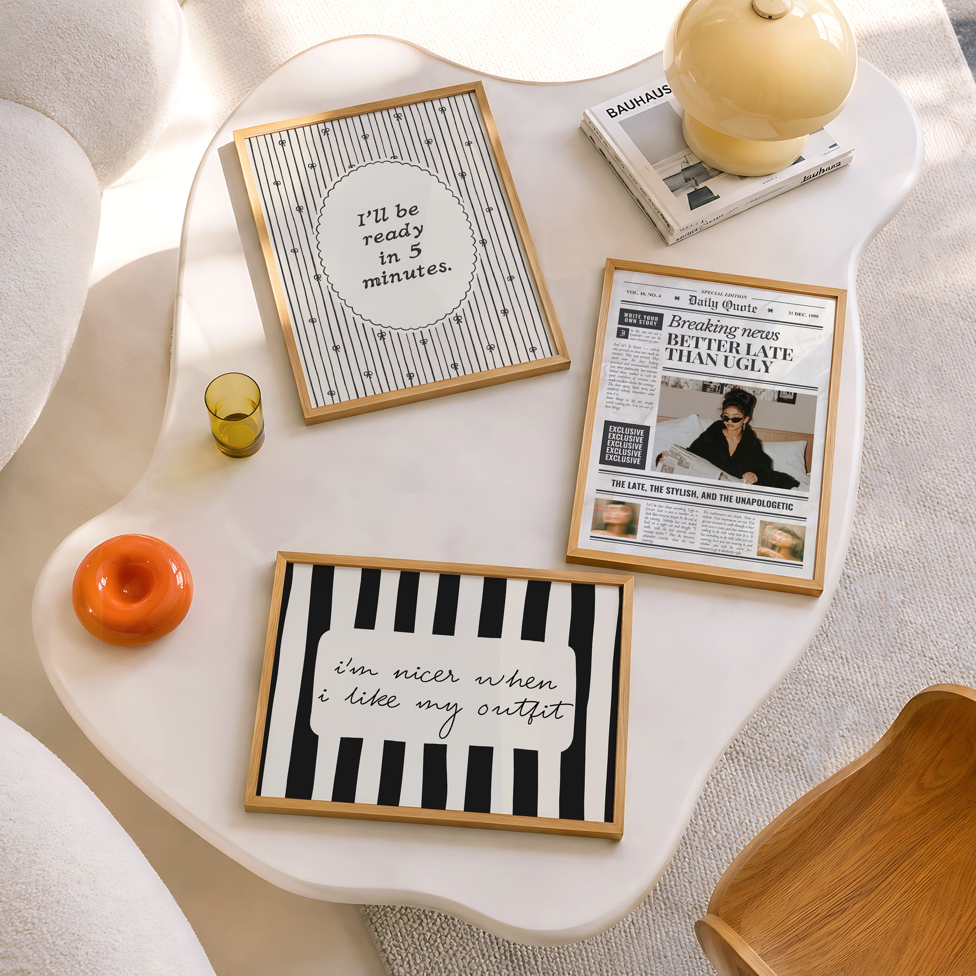 Set of 3 prints: a vintage-style "Daily Quote" newspaper front page reading "Breaking News: Better Late Than Ugly" with a fashion editorial photo of a woman in sunglasses reading a newspaper in bed, a scalloped oval print reading "I'll be ready in 5 minutes." in thin script surrounded by hand-drawn bows, and a black and white striped print with the handwritten quote "I'm nicer when I like my outfit."