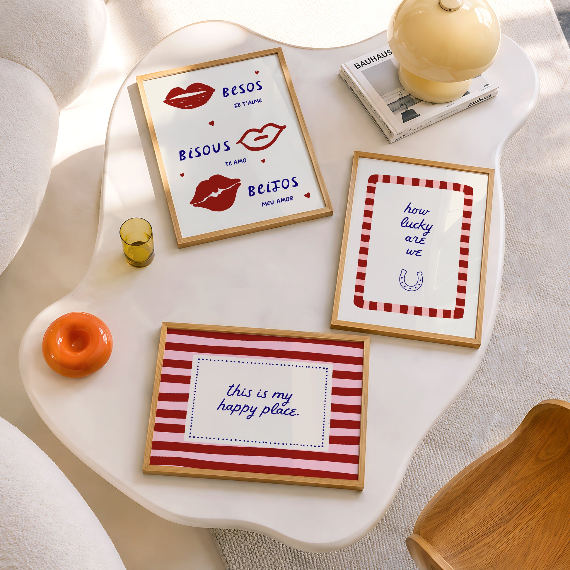 Set of three prints featuring "How lucky are we" with a horseshoe, "This is my happy place" in red stripes, and "Besos, Bisous, Beijos" with illustrated lips