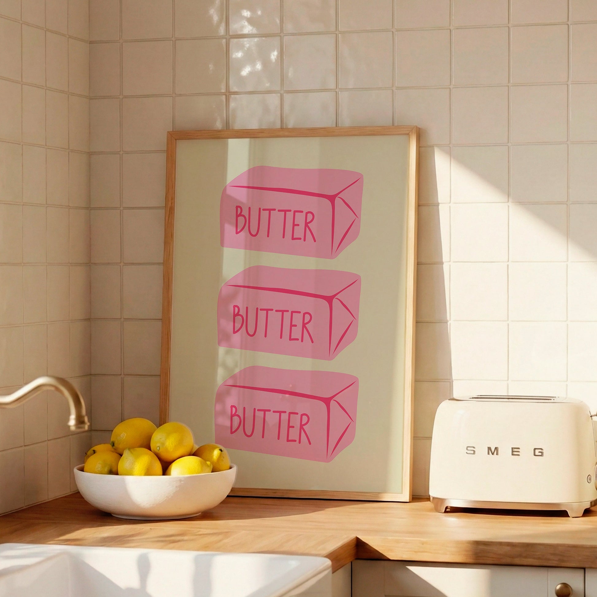 Vertical sage green wall print featuring three stacked illustrated pink butter blocks each labelled BUTTER in bold pink handwritten font
