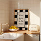 Black and white checkered print with a scalloped border and the handwritten quote "Kisses if you do the dishes" in black script