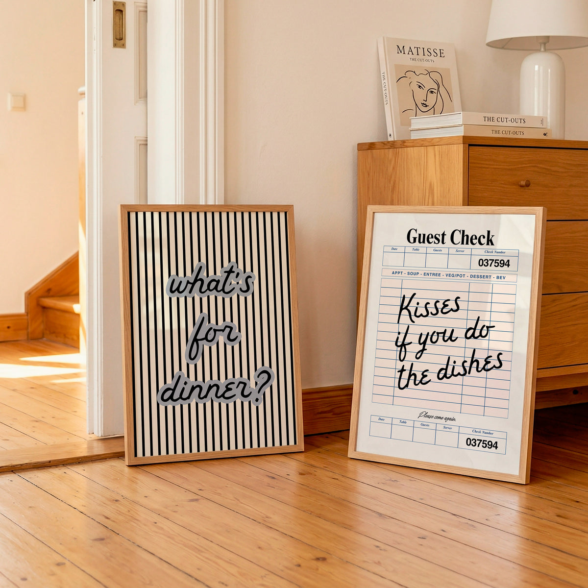 Set of two kitchen prints: "What's for dinner?" in bold striped typography, and "Kisses if you do the dishes" styled as a vintage guest check ticket